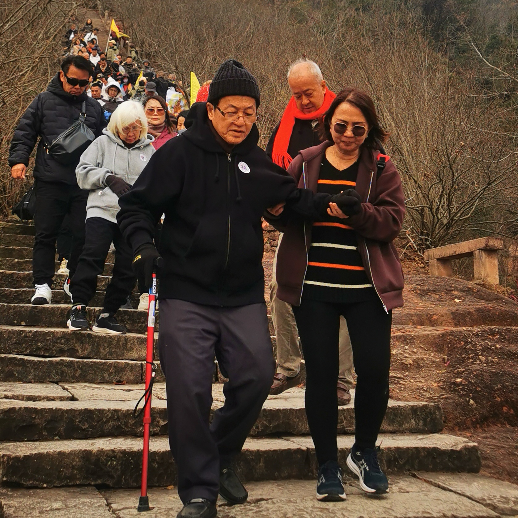 Visitors walking together on a mountain path during a China retreat journey