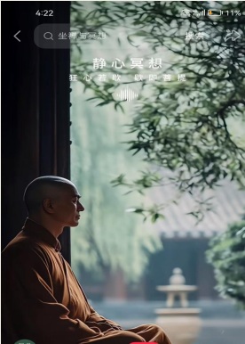 A monastic seated in quiet meditation beside a garden